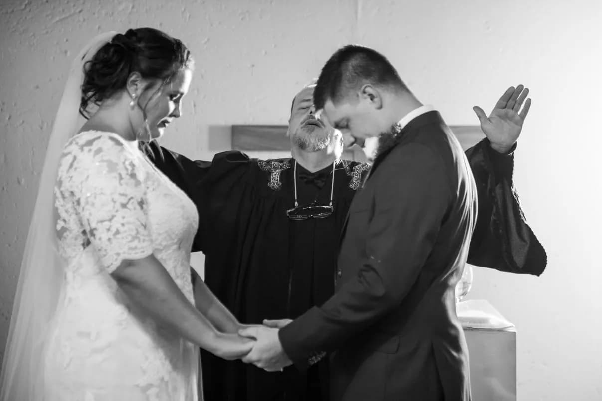 Dr Heinrich Lottering blessing a bride and groom during their wedding vows